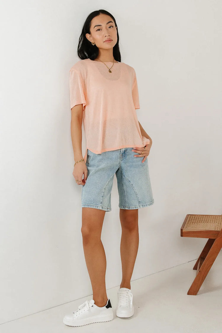 Basic top in peach paired with a light wash bermuda 