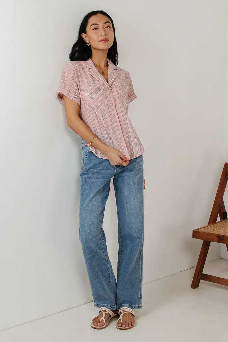 Button up in pink paired with a medium wash denim 