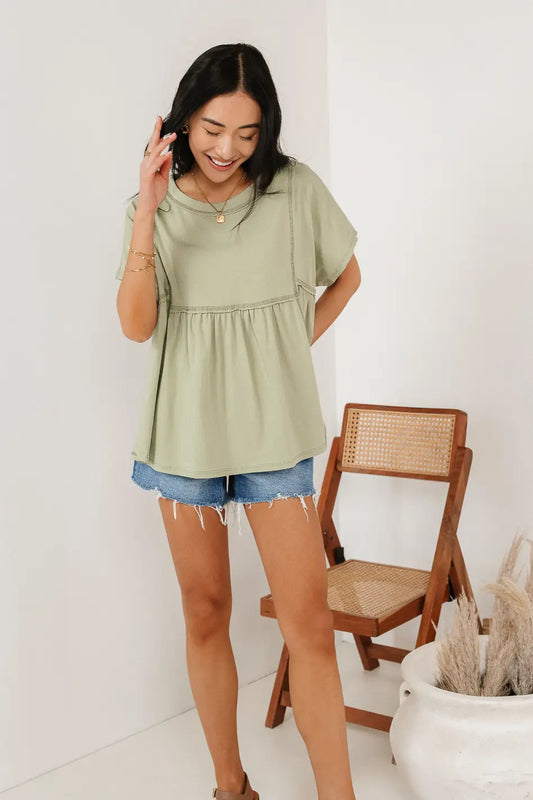 Peplum top in sage paired with a denim short