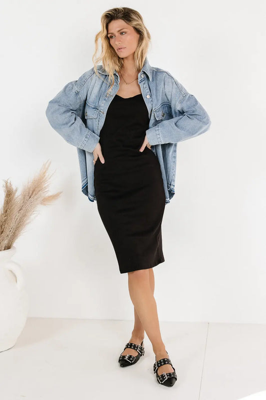 Dress in black paired with a denim jacket 