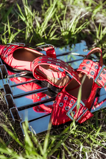 two buckles on red shoes