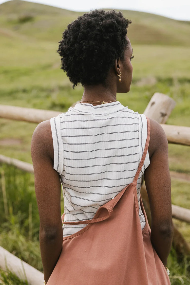 Striped tank in white paired with a jumpsuit 