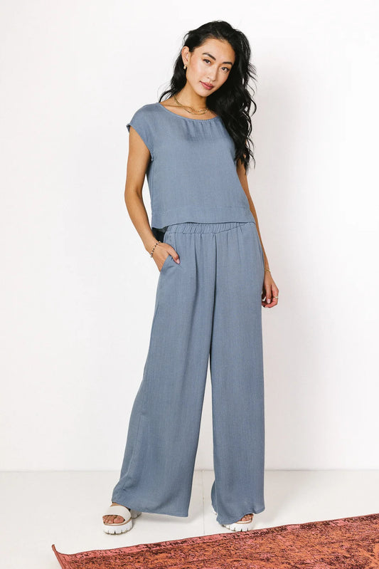 Top paired with a wide leg pants in slate 