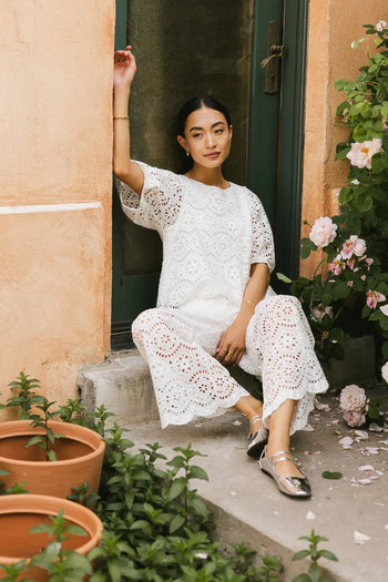Pants in white paired with a white top 