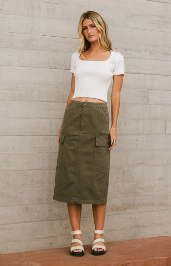 Top in white paired with an olive cargo skirt 