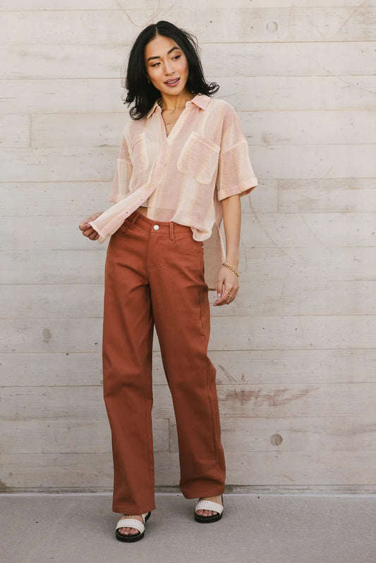 Button up paired with a pants in brick 