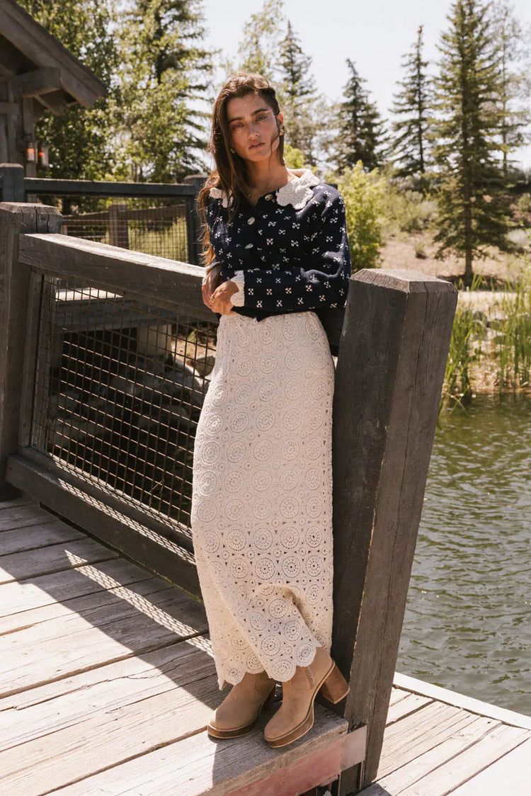 Sweater in navy paired with a skirt in oatmeal 