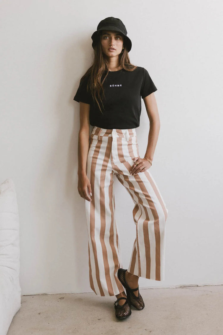 Top in black paired with a striped pants 