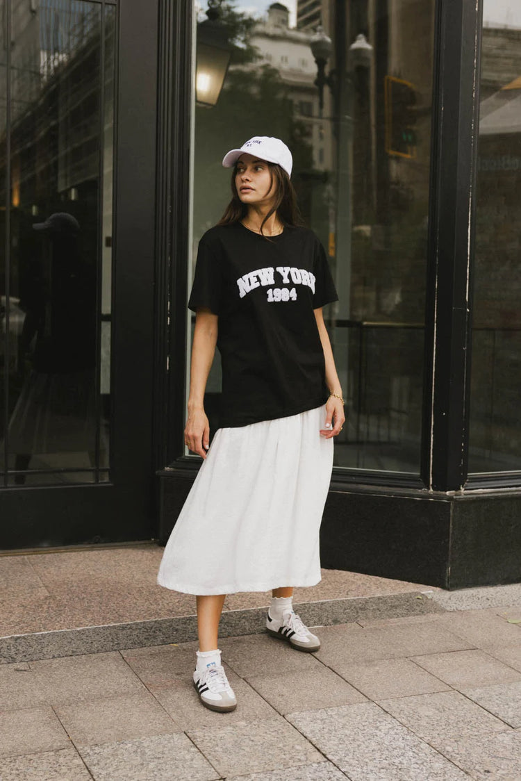 Top in black paired with a midi skirt in white 