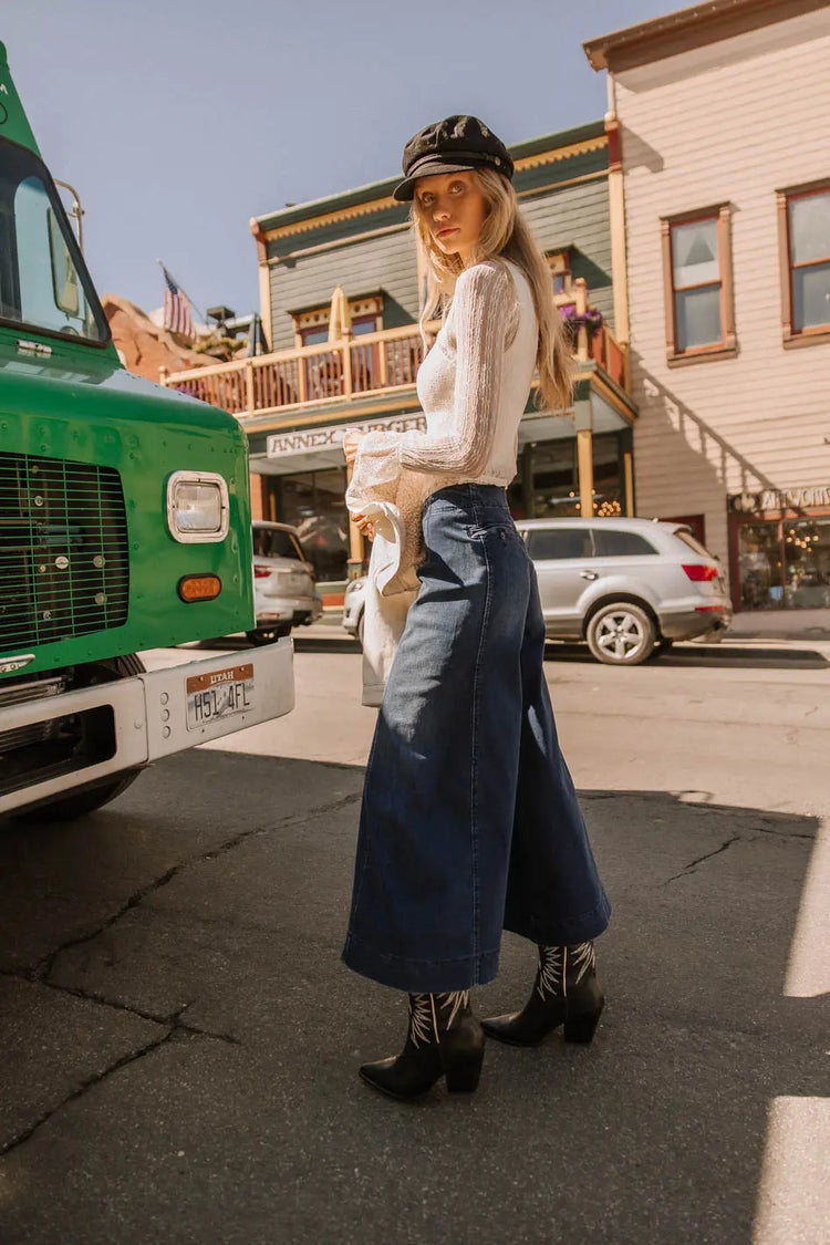 Denim pants in dark wash paired with a lace top 