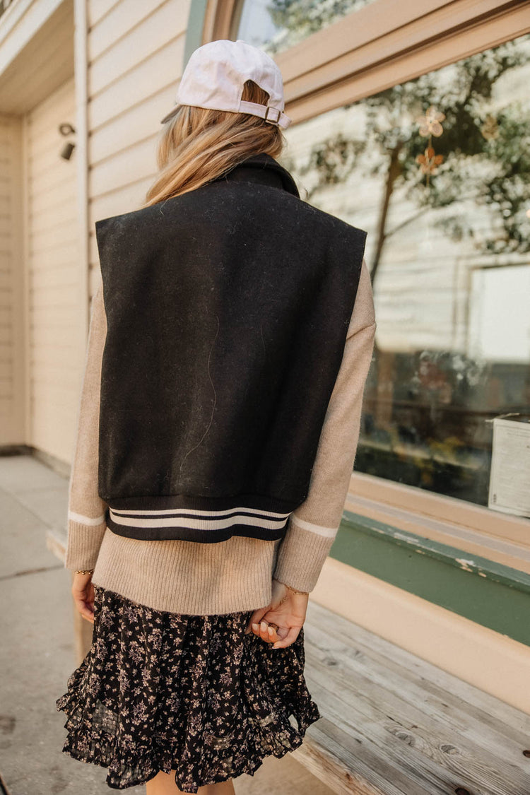 black vest with white stripes
