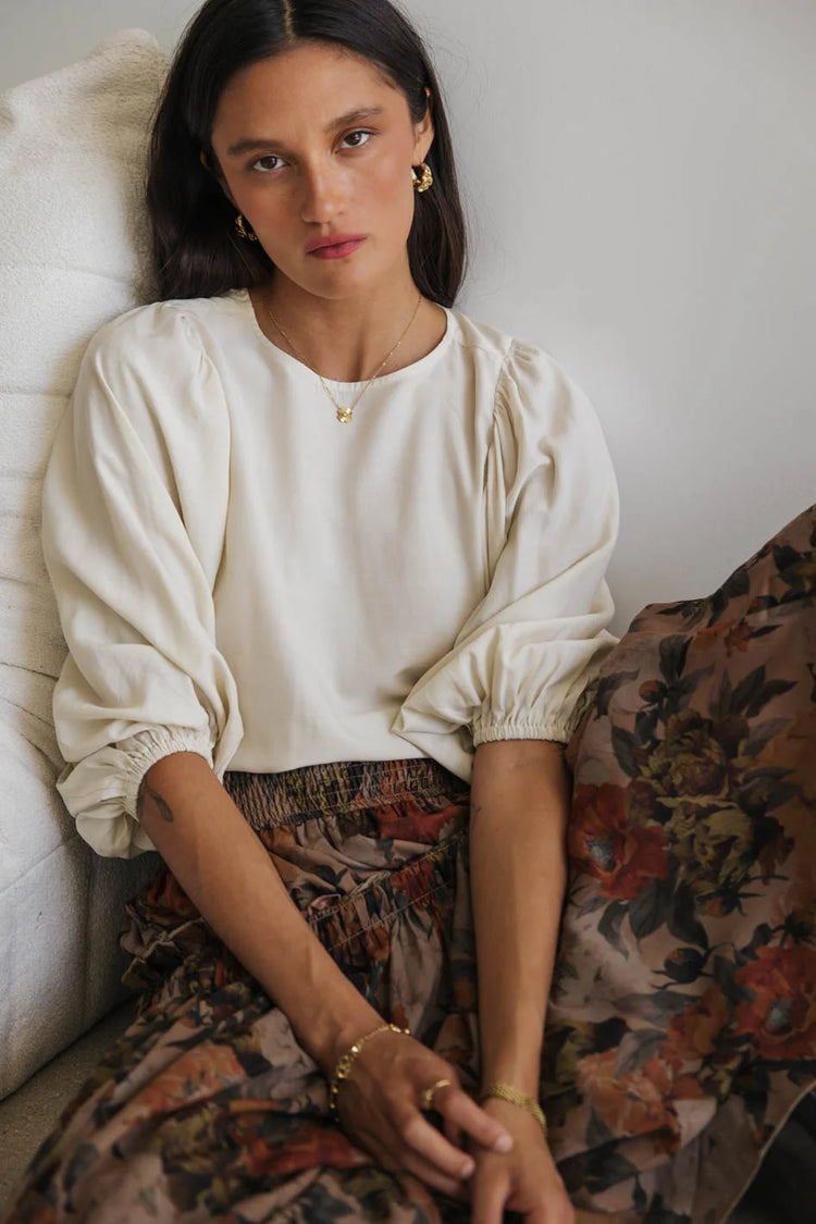 Blouse in cream paired with an skirt 