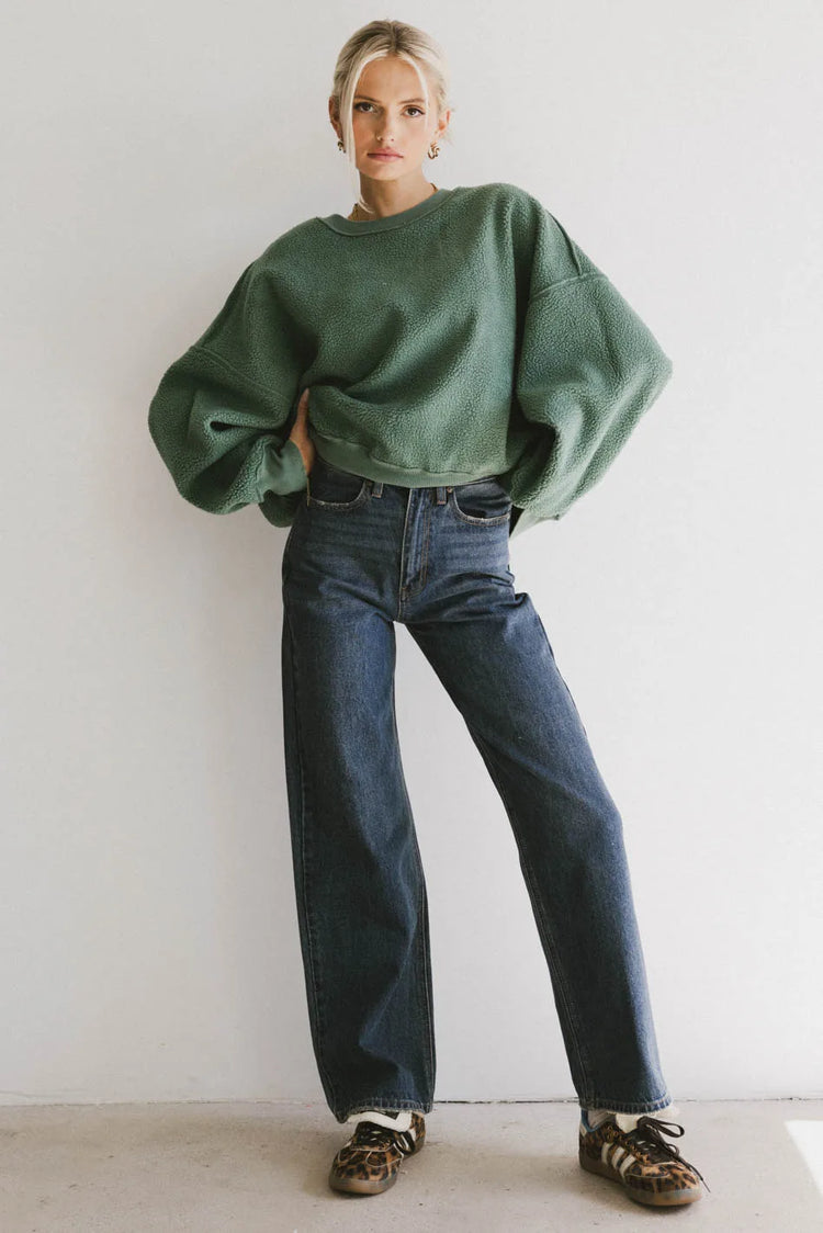 Sweatshirt in green paired with a dark wash denim 