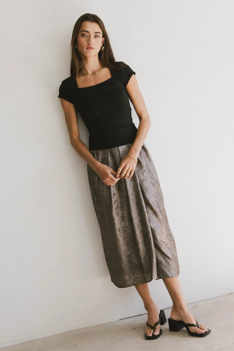 Midi skirt in gold pared with a black top 