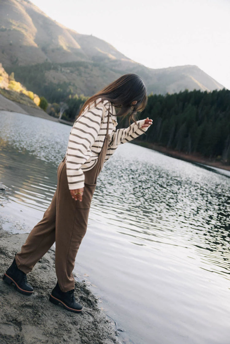 Striped top paired with a camel overall 