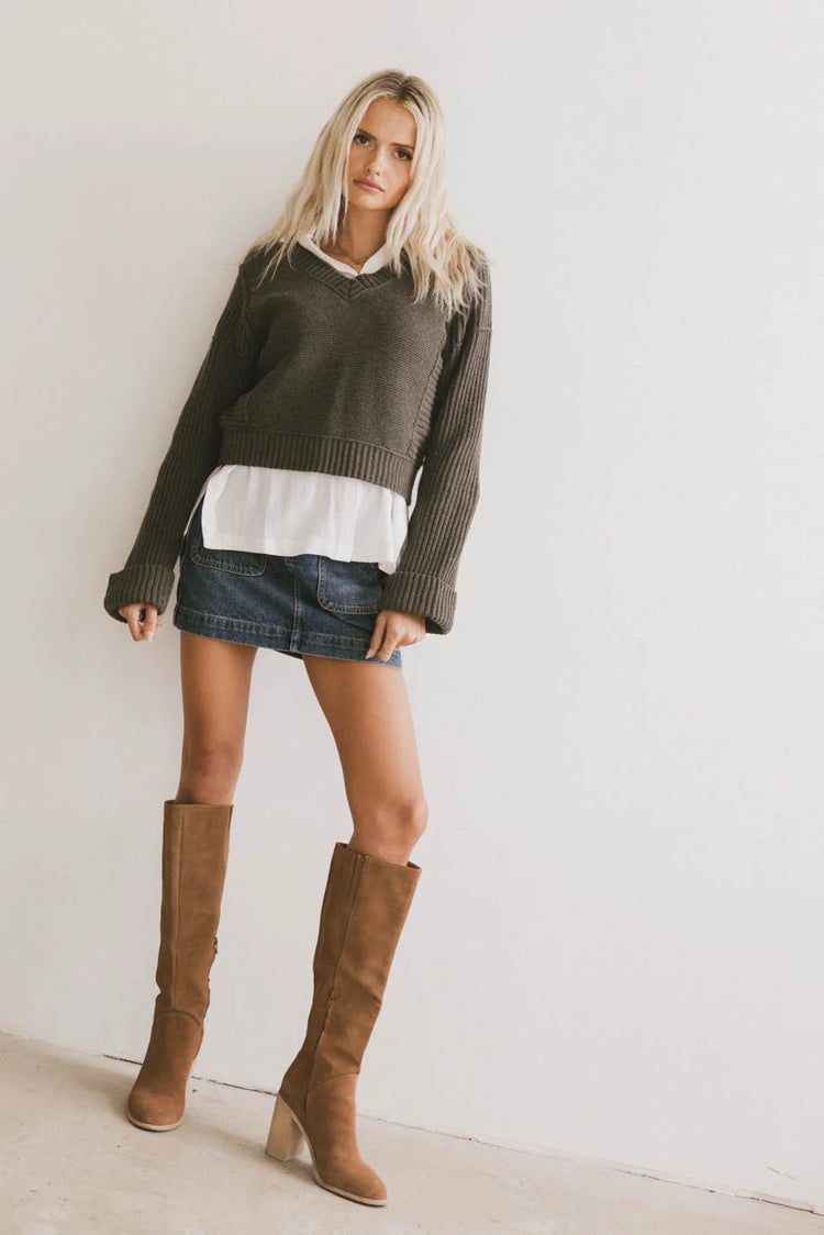 Sweater in olive paired with a denim mini skirt 