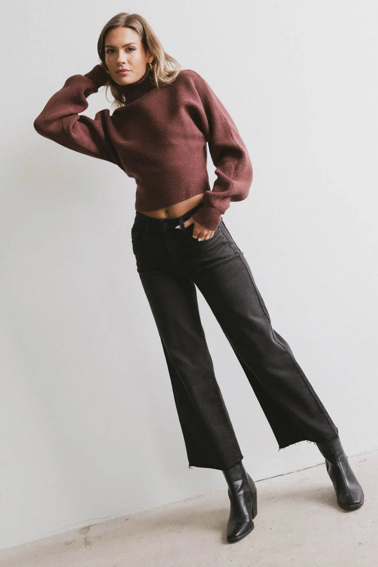 Top in wine paired with wide leg jeans in black 