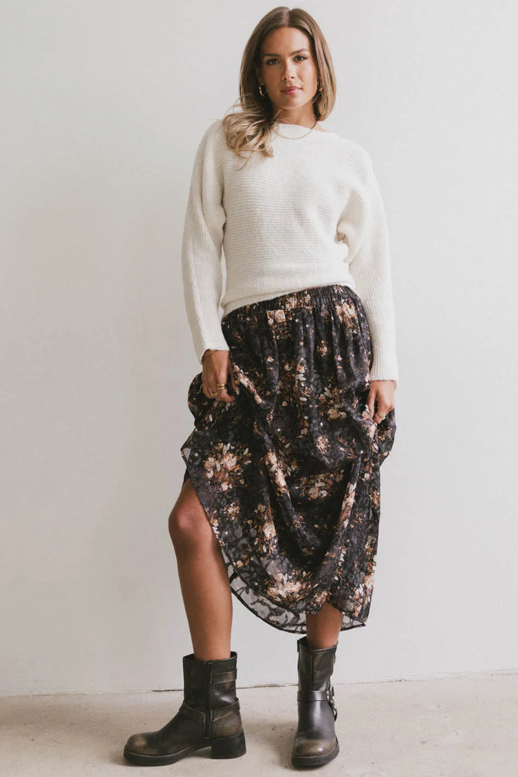 Top in cream paired with a floral skirt 