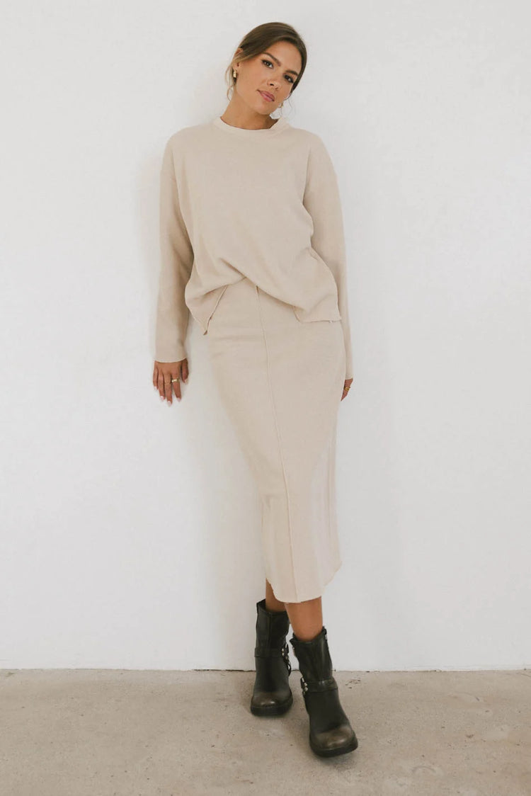 Knit sweater in tan paired with a midi skirt in tan 