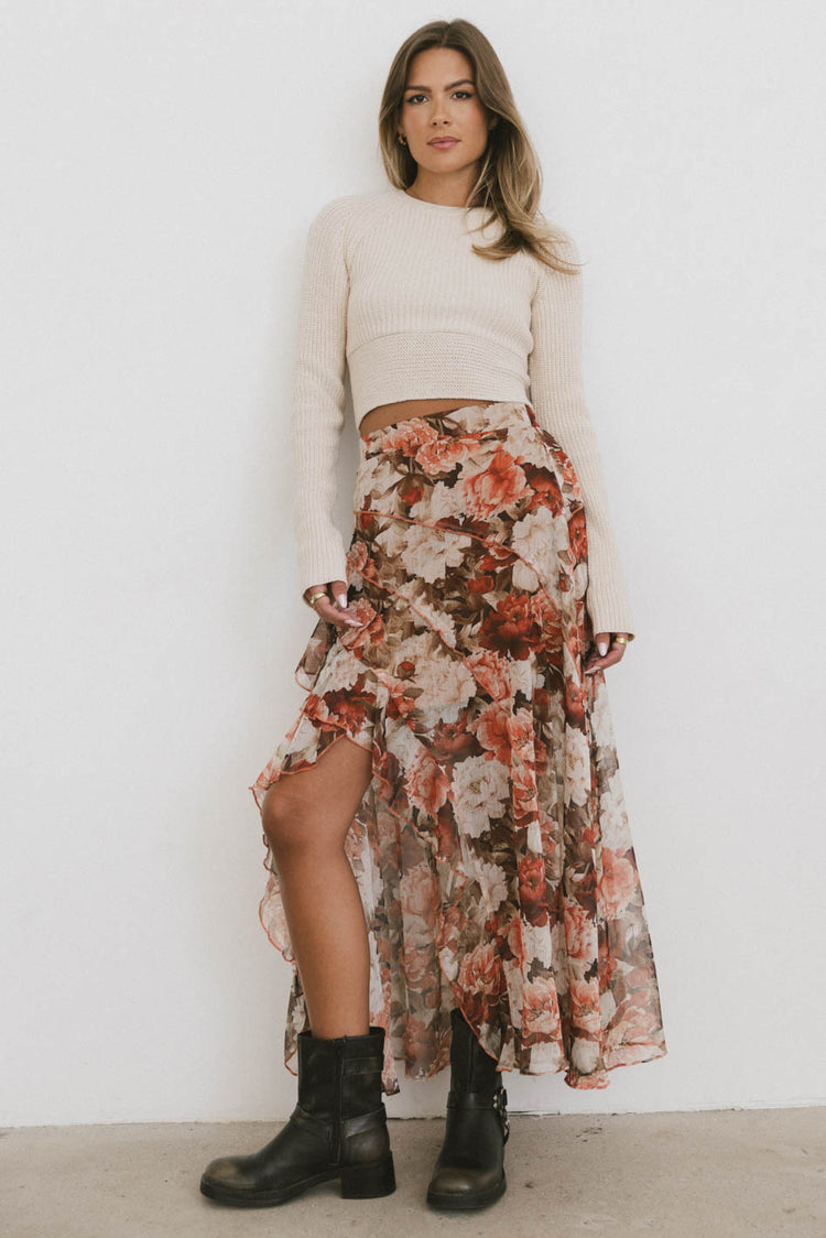 beige ribbed sweater with floral print skirt