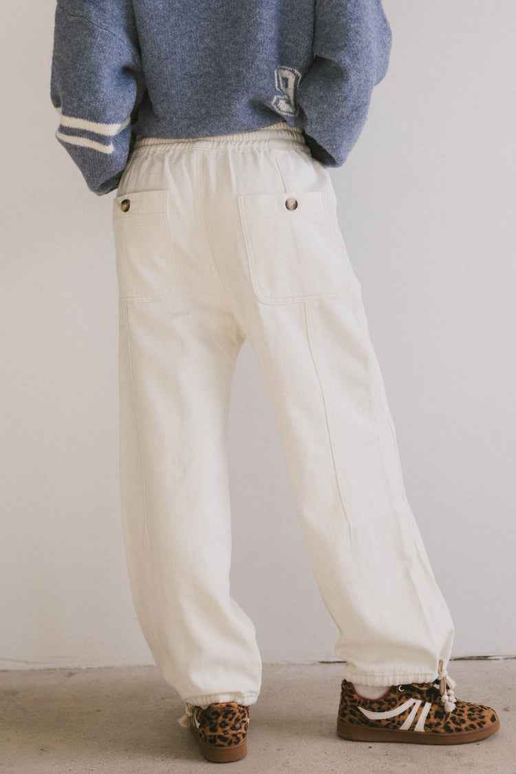 cream pants with button detail pockets