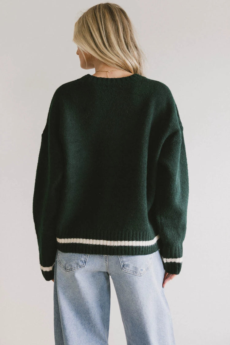 stripped trim on green sweater