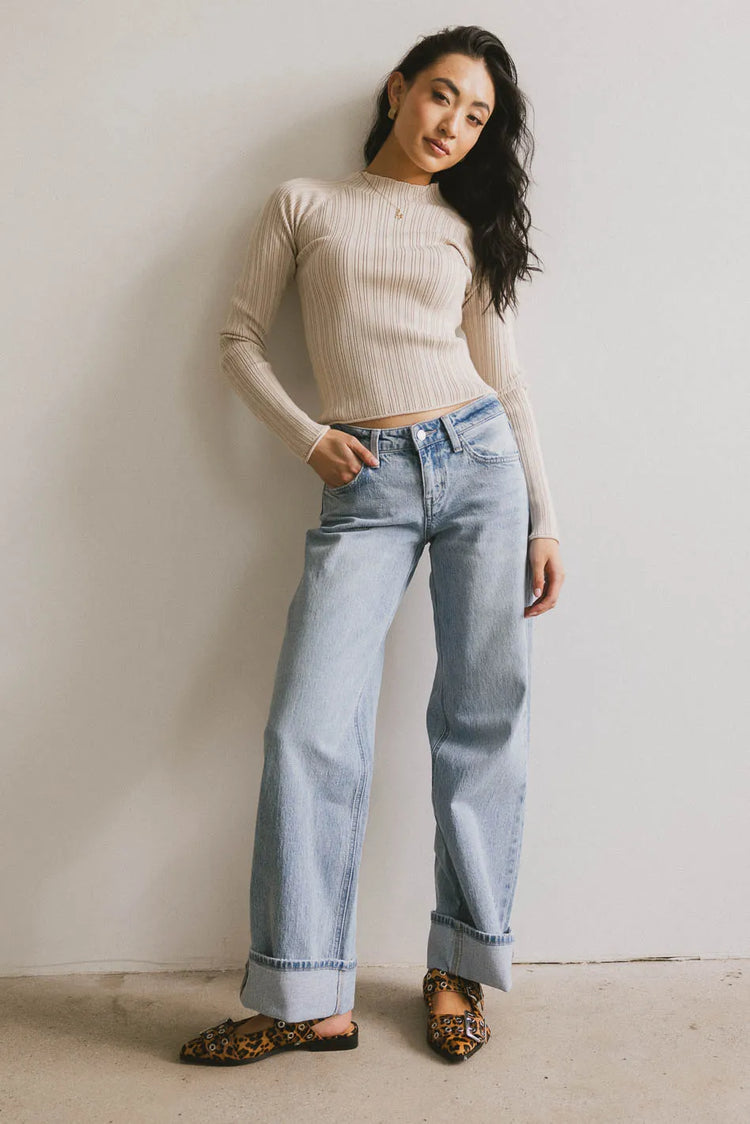 Striped top in beige paired with light denim 