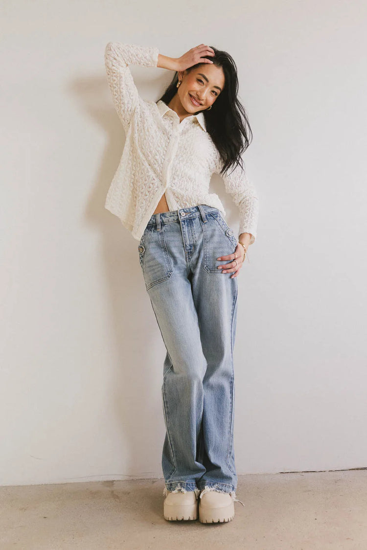 Top in cream paired with light wash denim 