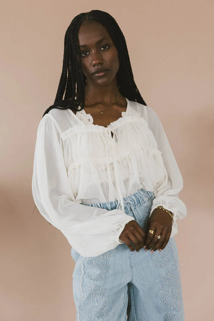 Front ruffle top in cream 