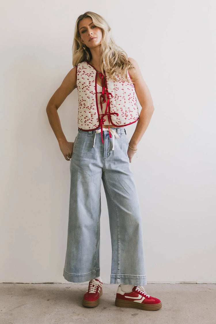 Vest in red paired with light wash denim 