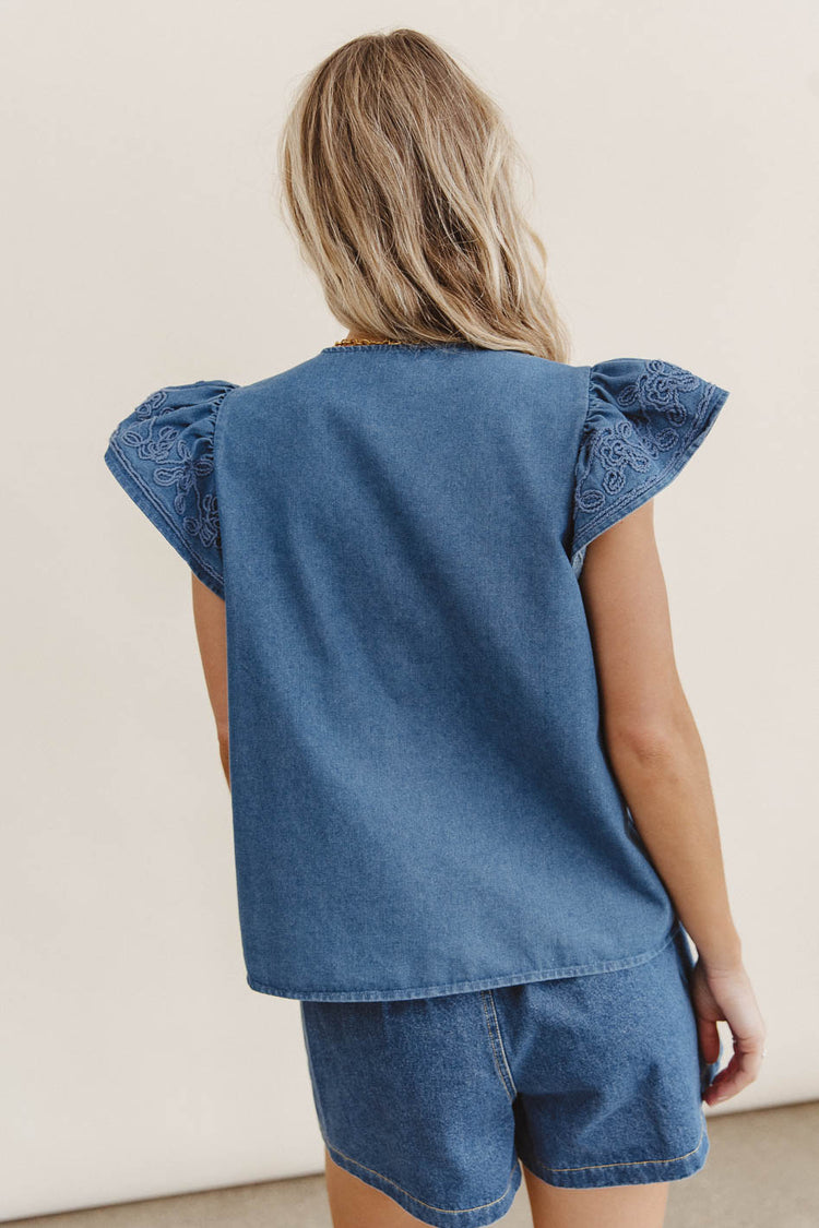 blue top with flutter sleeves