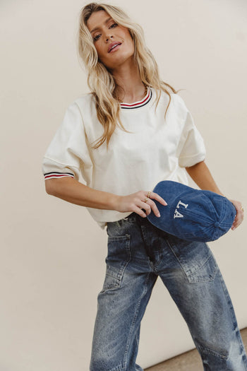 boxy white top with strip detail on the sleeve