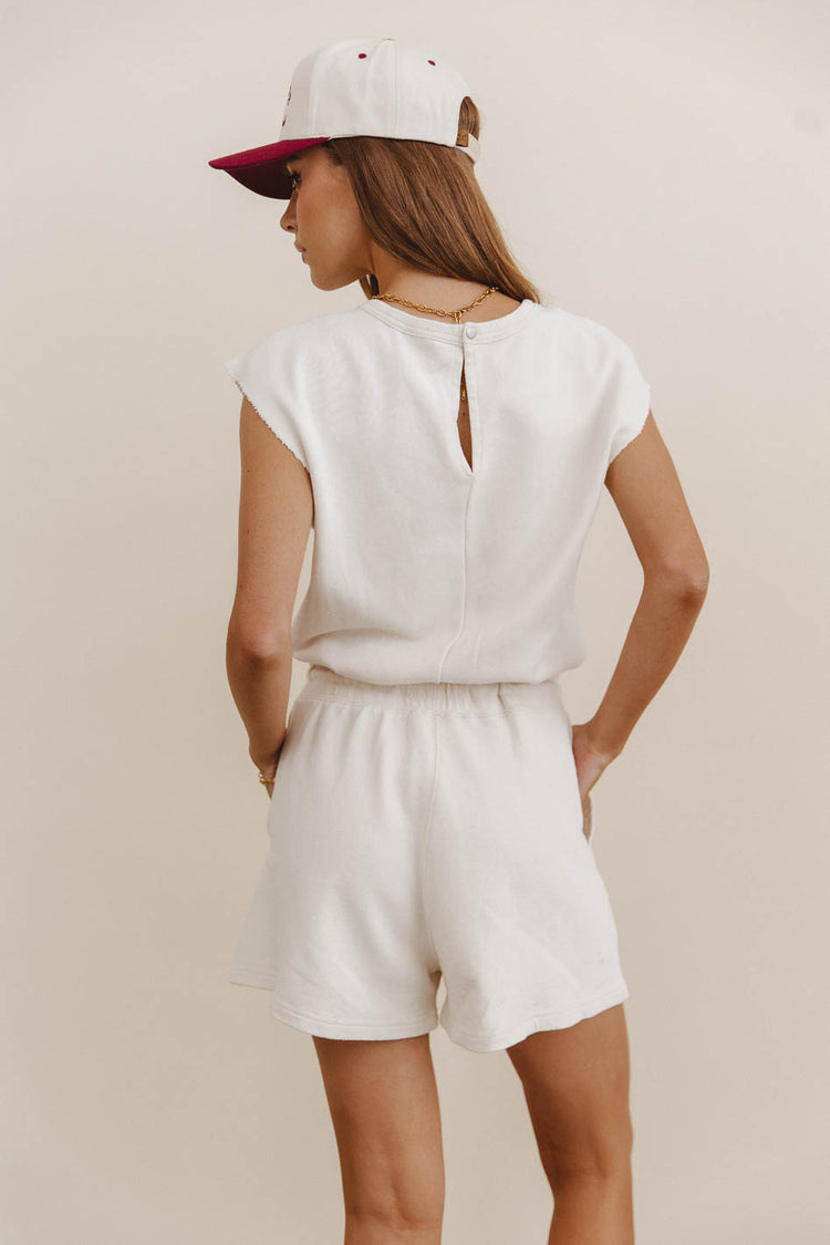 cream romper with open back detail