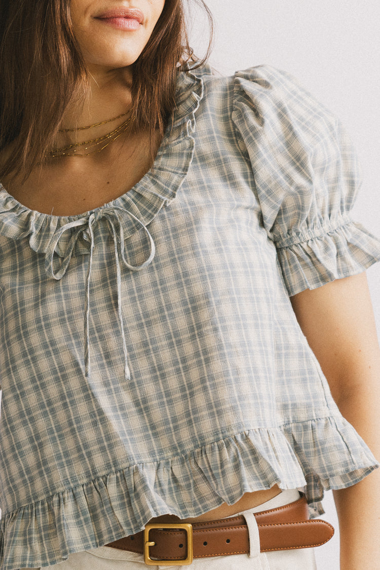 bow tie on chest of plaid top 