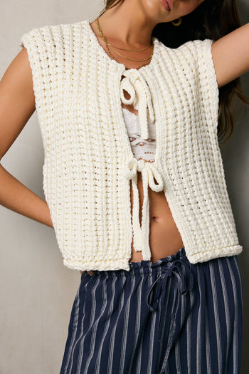 white sweater vest with two front ties