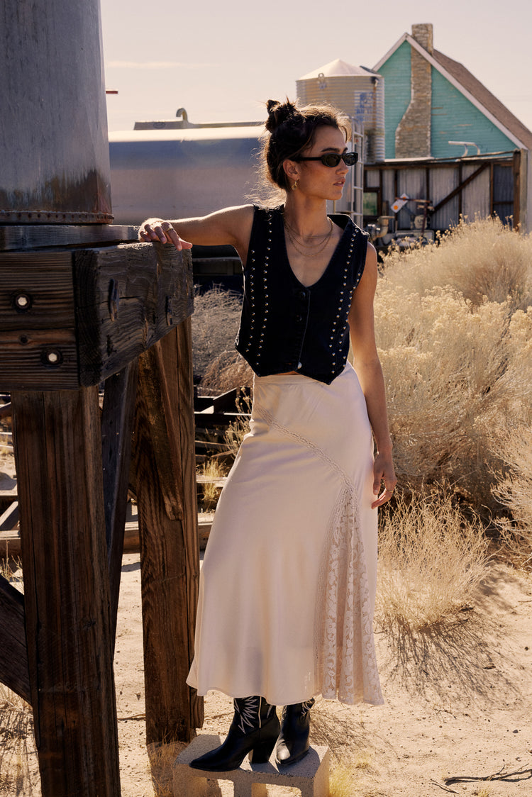 cream maxi skirt with lace detail with black vest