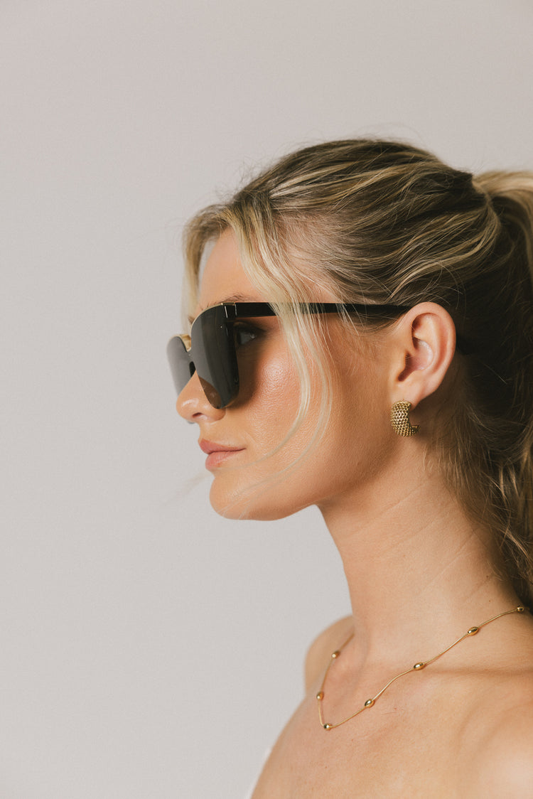 oversized black and gold glasses