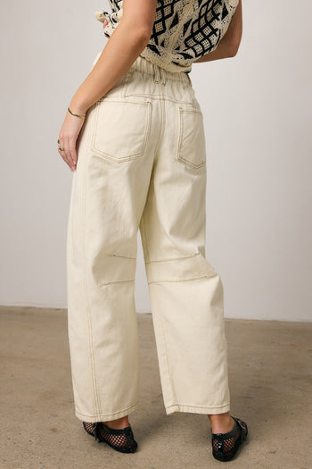 cream jeans with brown stitching