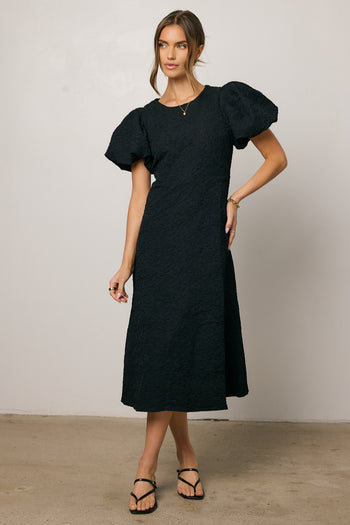 black dress with puff sleeves