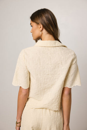 cream top with embroidered detail