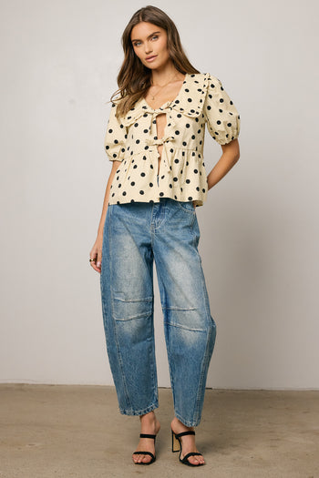 cream blouse with black polka dots