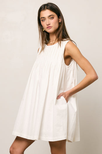 white pleated dress with pockets