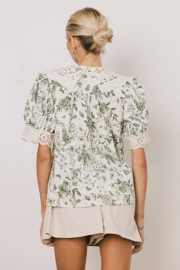 white blouse with green florals