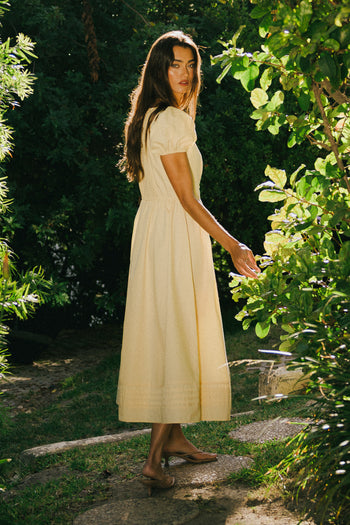 yellow dress paired with brown heels 