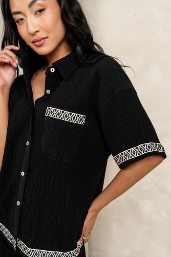 black button up with a pocket on the chest