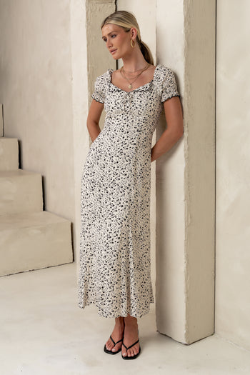 scalloped v neckline line with a small bow