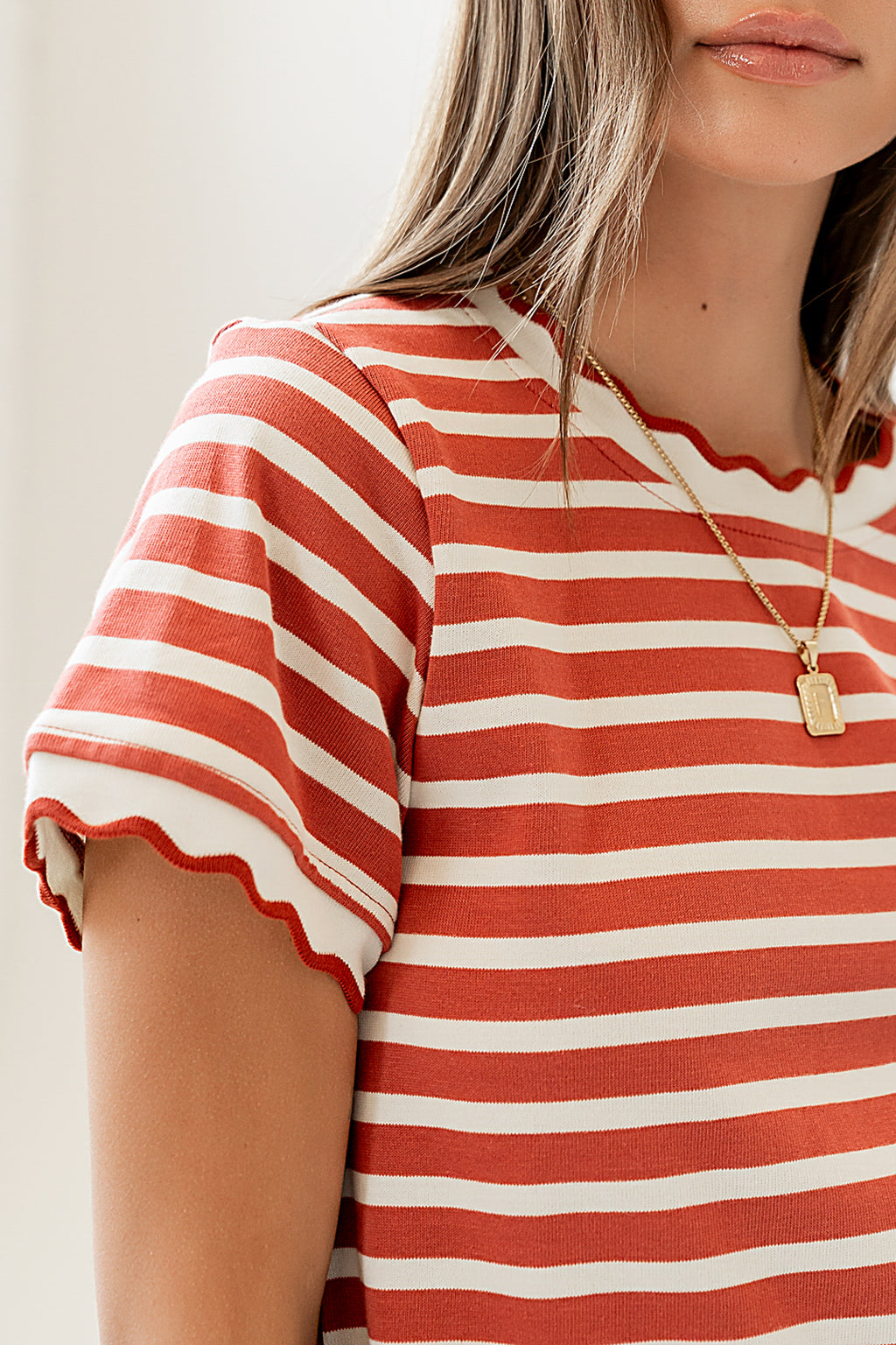 red striped top with scalloped detail 