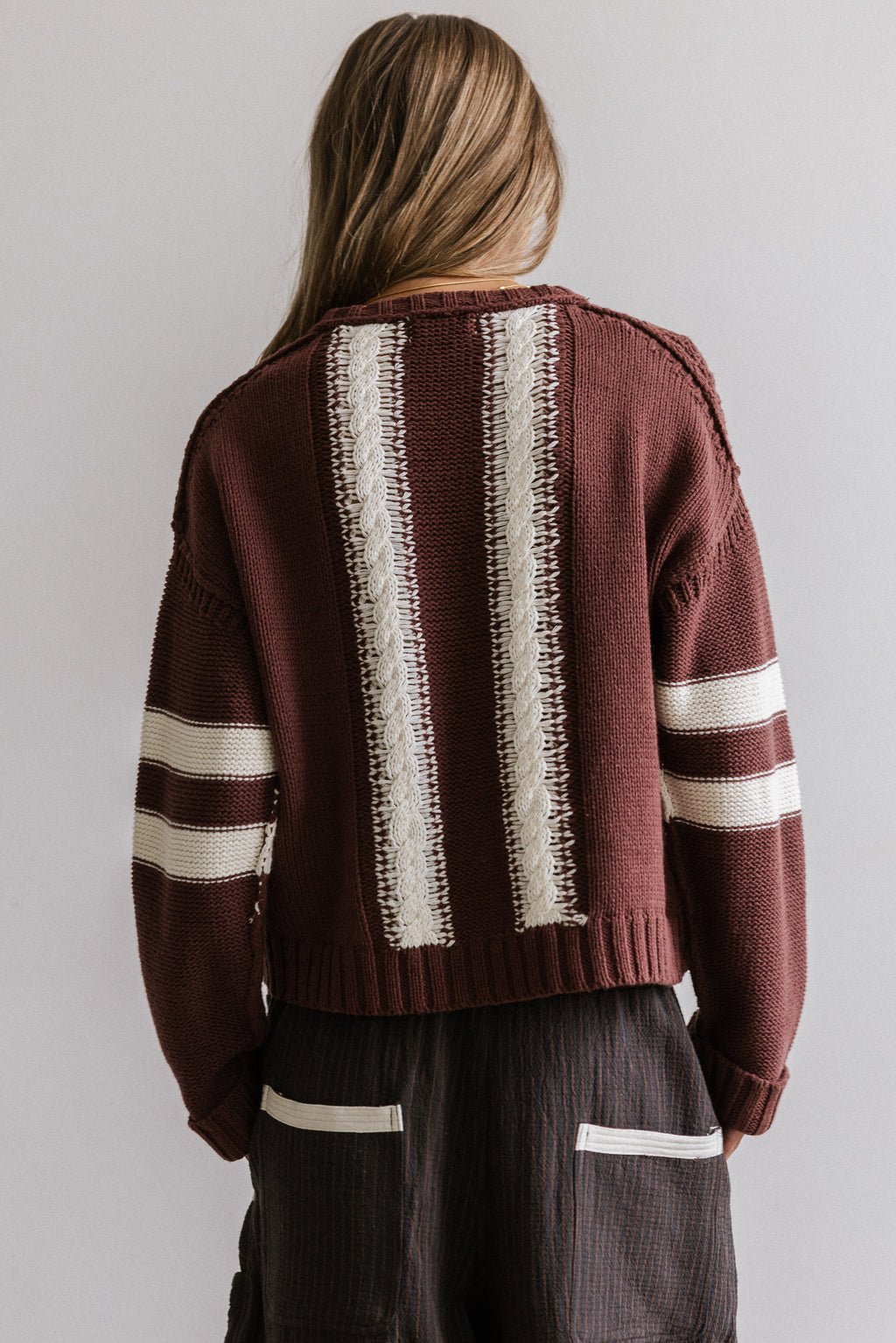 TWO STRIPES DOWN THE BACK OF SWEATER 