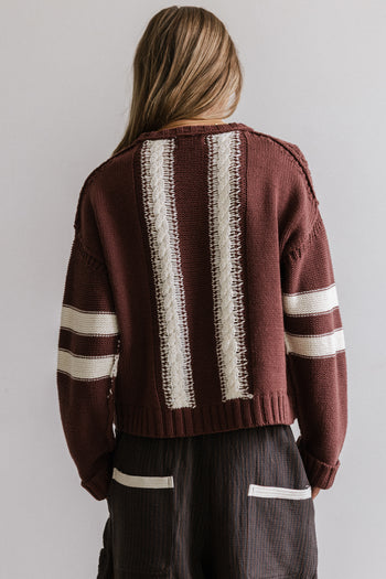 TWO STRIPES DOWN THE BACK OF SWEATER 