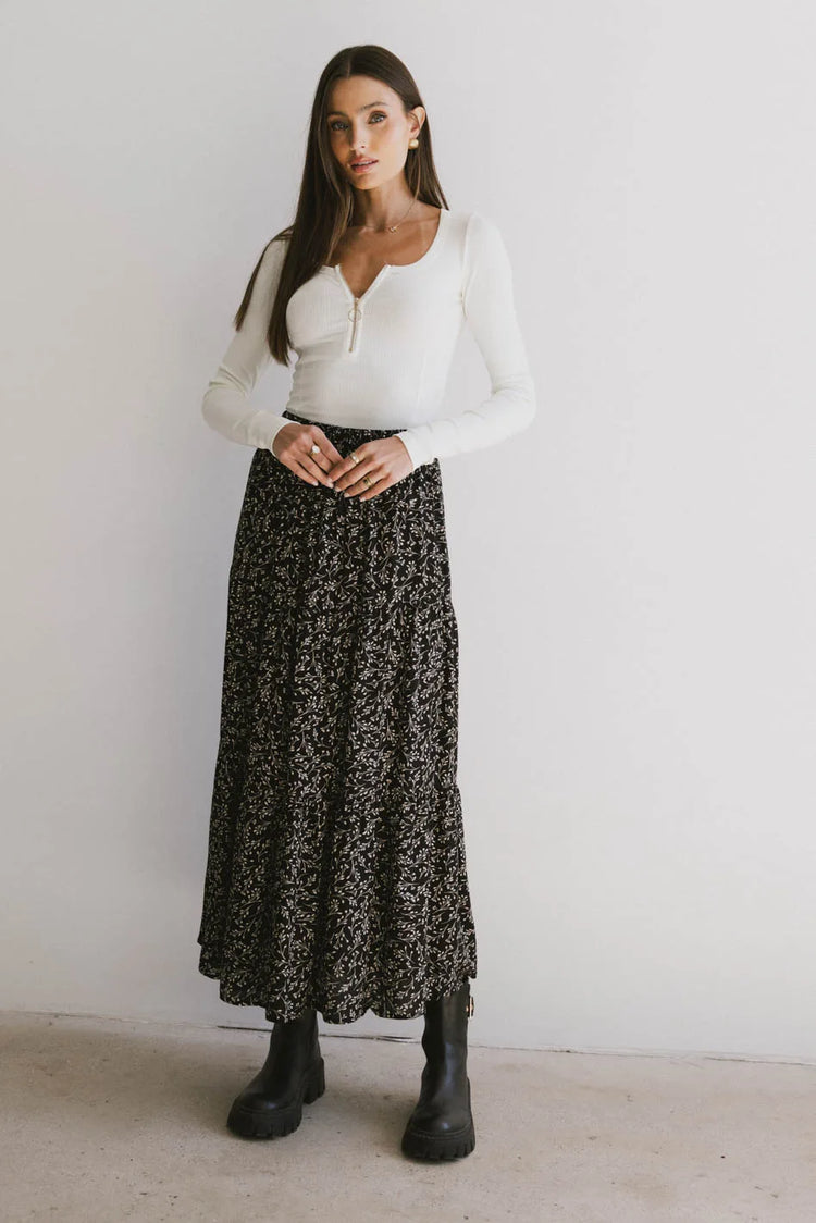 Top in ivory paired with a black floral skirt 